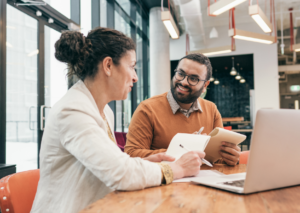 Manager and employee discussing a Performance Improvement Plan in an office