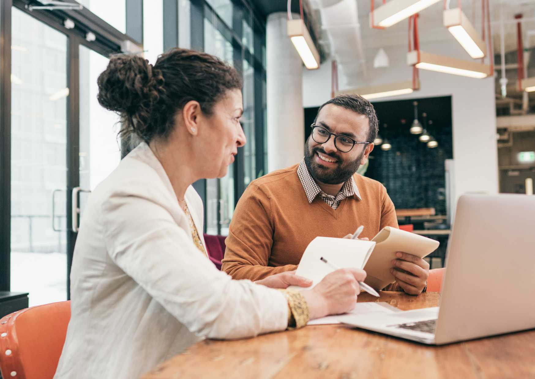 Manager and employee discussing a Performance Improvement Plan in an office