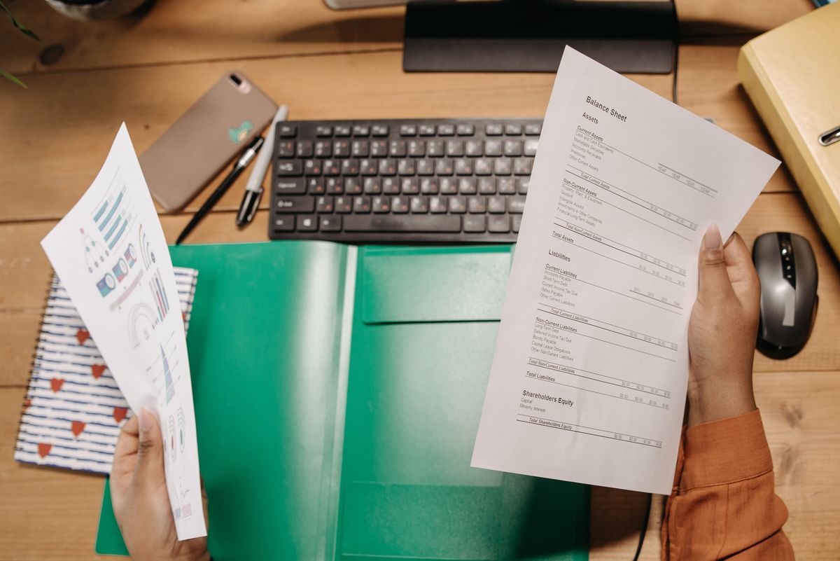 Person holding a statement while tracking employee progress